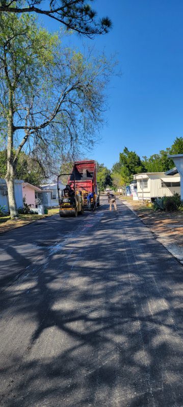 M&S Asphalt Paving crew and equipment laying a new asphalt surface on a Central Florida community street